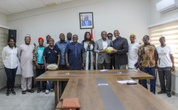 Minister of Youth and Sports holding rugby ball with Rugby Africa President.jpeg