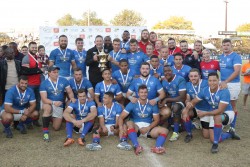 Namibia captain Johan Deysel and coach Phil Davies hold the Africa Gold Cup trophy, surrounded by th